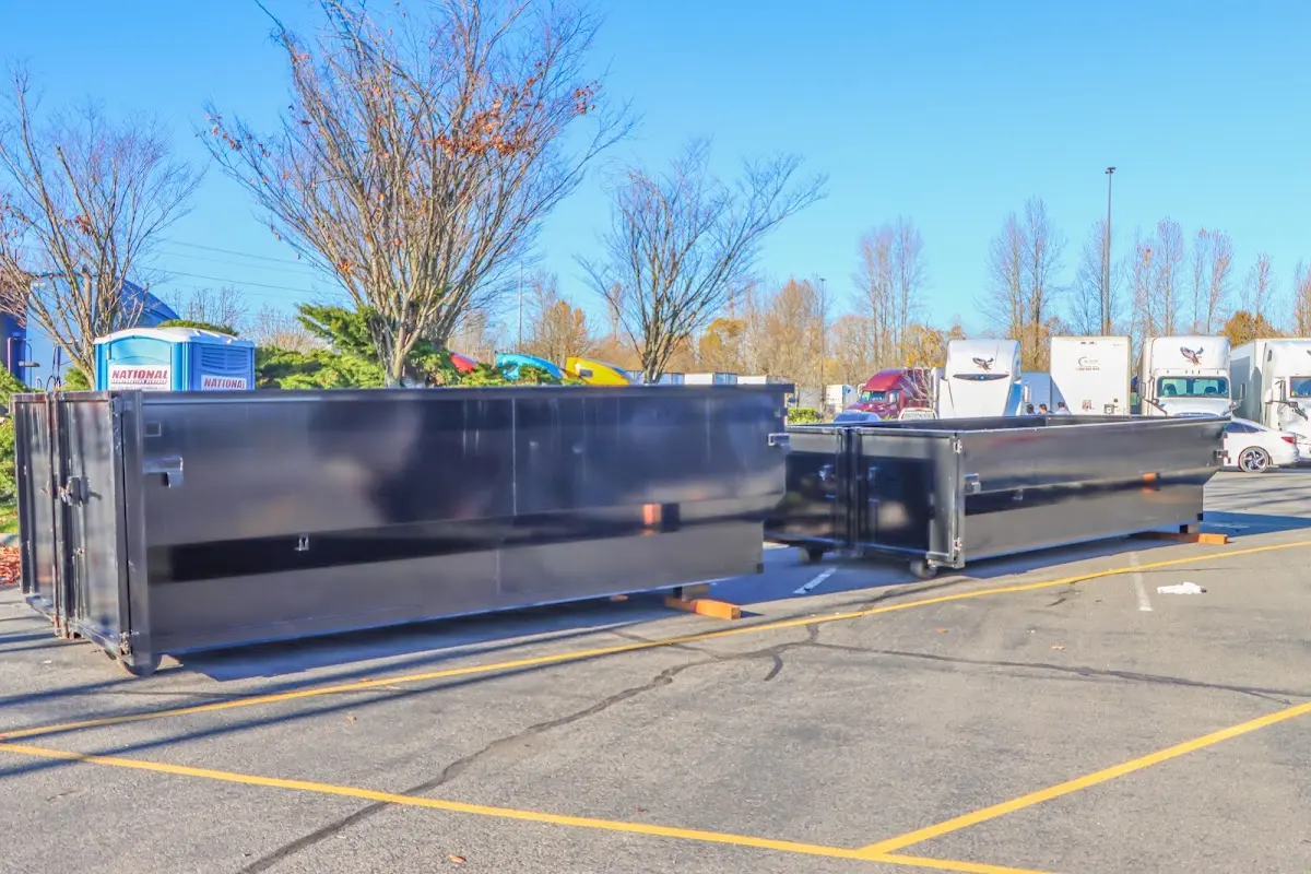 Professional dumpster rental service with roll-off container on residential driveway in Greencastle